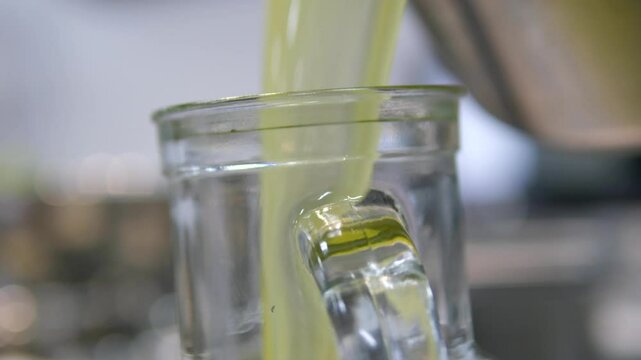 pour lemonade into a saucepan Pear and cherry plum home made lemonade: stirring the sugar with the tablespoon