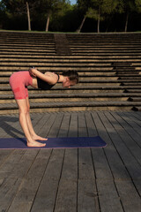 Woman practicing yoga stretches in a natural outdoor setting