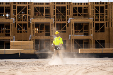 A construction worker in highvisibility gear emphasizes safety and professionalism at a dusty work site