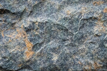 Fototapeta premium Rugged grey stone texture with patches of orange