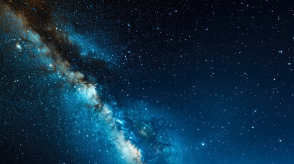 Fototapeta premium Starry night sky with the Milky Way galaxy visible on the left side, set against a deep blue space. The image captures the vastness and beauty of the universe.