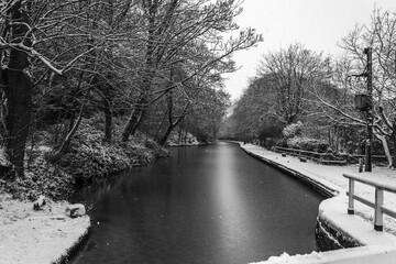 Newly fallen snow marks out the tow path of the Leeds and Liverpool Canal from Hirst Lock towards Bingley