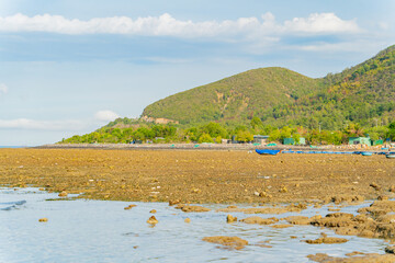 The sea ebb at sunset.
The coastline is the seabed. Seascape of Nha Trang suburb in Vietnam. 