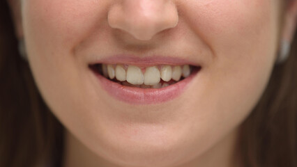 Close-up of a young woman's lips with a smile