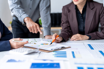 Business team analyzing financial charts and graphs on desk