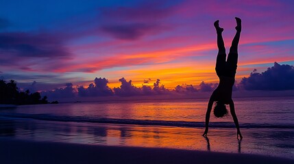 Person doing handstand on a beach at sunset with vibrant colors reflecting in the water