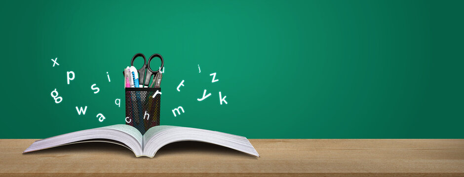 International Literacy Day concept of open book with alphabet letters. Children education background or learning event concept.