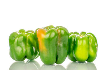 Three sweet green peppers, macro, isolated on white background.