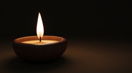 A tranquil candle flame illuminates a dark space, creating a serene atmosphere perfect for relaxation or meditation.