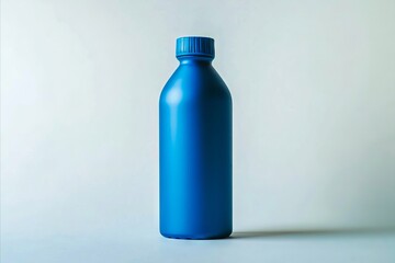 Naklejka premium A blue plastic bottle sitting on top of a table