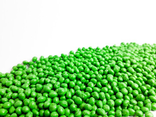 Green prairie masterbatch granules on white background. Color pigment carrier polymer in plastic industry