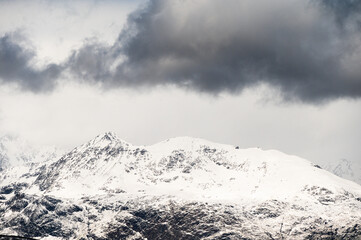 snowy landscape with snow-covered mountains along the road from Alta to Tromsoe, Norway