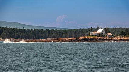 lighthouse on rocky Maine Shore