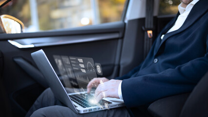 Businessman Working on a Laptop in a Car