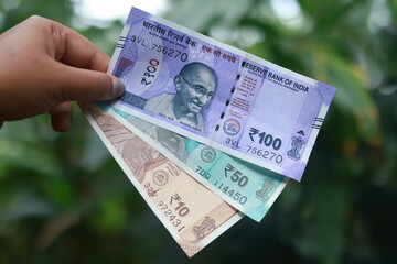 Holding indian Currency, Hundred rupee, Fifty rupee, Ten rupee note