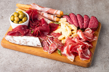Charcuterie board. Antipasti appetizers of meat and cheese platter with salami, prosciutto crudo or jamon and olives