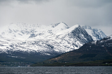 snowy landscape with snow-covered mountains along the road from Alta to Tromsoe, Norway