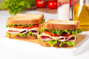 Club sandwich with ham, cheese, tomato and lettuce. 