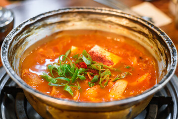 Kimchi Stew in a Metal Pot Placed on the Stove, Before Boiling