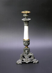 Antique candlestick closeup on grey background