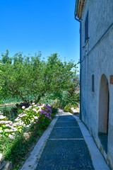 A narrow street between the old houses of Scapoli in Molise, Italy.