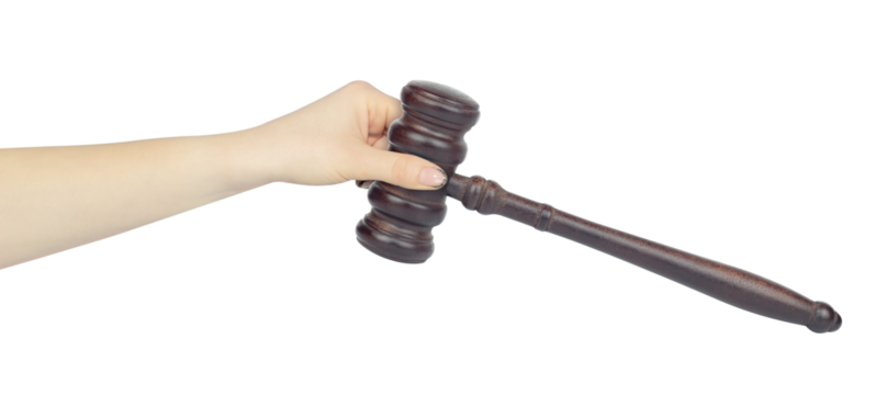Judge's gavel, chairman's gavel, wooden gavel in hand, outstretched hand with Judge's gavel isolated from background, concept of refereeing, transfer of leadership
