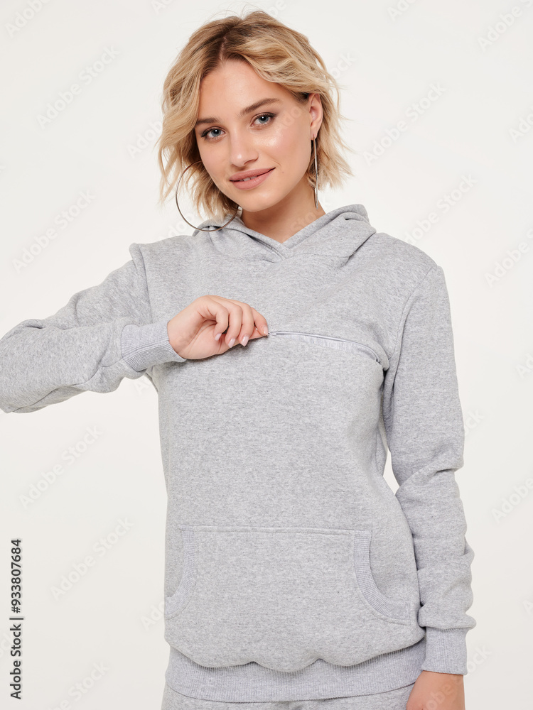 Wall mural pregnant woman in casual clothes, white background in studio