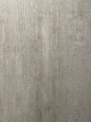 Fototapeta premium Marble Tile texture closeup as an abstract background. Natural Honed stone slab. Details of matte ceramic wall or floor. Gray surface with satin finish and a pattern of random irregular white spots.