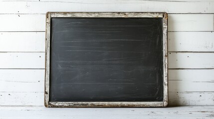 An old, vintage chalkboard with distressed edges set against a white wooden wall, evoking a rustic, educational vibe for creative design.