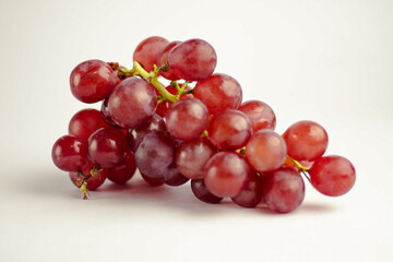 Fresh and ripe red grapes isolated on white background. Clipping path. Healthy organic fruit.