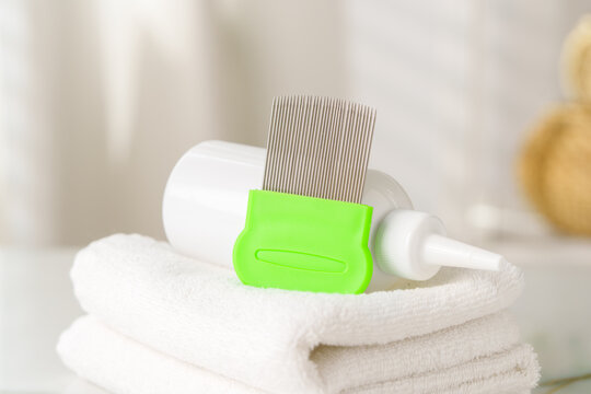 Bottles of Lice Treatment Products and a Comb on a Countertop