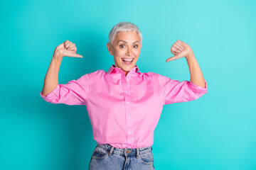 Photo of nice aged woman point fingers self wear pink shirt isolated on teal color background