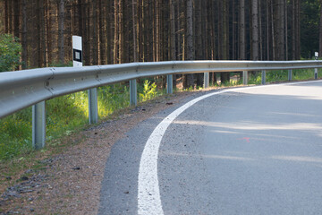 Obraz premium Road with asphalt coating. Heavy and light vehicle movement a road among the mountains. Paved road for car traffic, construction of a new paved road for transport in rural areas