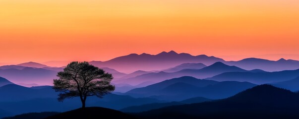 Naklejka premium Solitary tree on hill against colorful mountain sunset, panoramic view. Nature tranquility and serenity concept