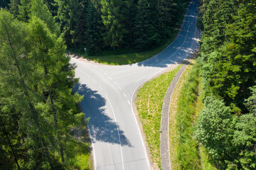 Road with asphalt coating. Heavy and light vehicle movement a road among the mountains. Paved road for car traffic, construction of a new paved road for transport in rural areas