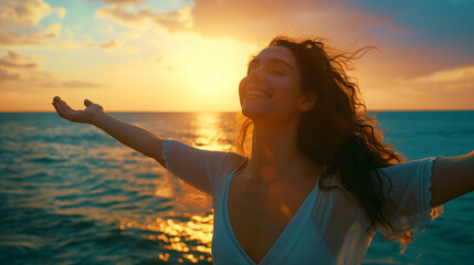 A woman extends their arms wide open, embracing the beauty of the sunset over the ocean, symbolizing freedom, peace, and connection with nature.