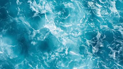 Obraz premium This image presents a stunning aerial view of ocean waves, showcasing the frothy white patterns against sparkling blue water, capturing the beauty and power of the sea in a remarkable visual.