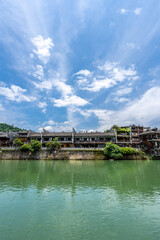 Fototapeta premium Green Water and Traditional Miao Village Architecture by the River in Fenghuang Ancient Town, Xiangxi, Hunan