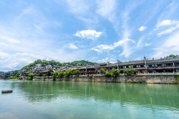 Fototapeta premium Green Water and Traditional Miao Village Architecture by the River in Fenghuang Ancient Town, Xiangxi, Hunan