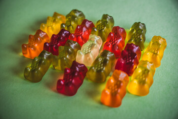 Colorfull gummy bears in a green background