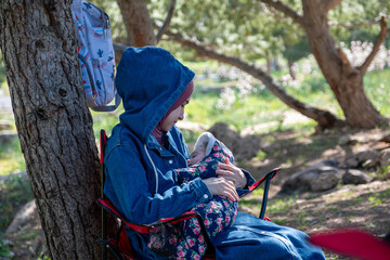 Mother and baby enjoying their time together on a picnic amidst green fields, creating lovely memories