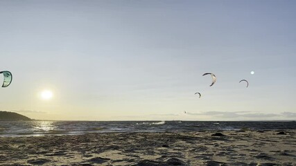 Kitesurfers take advantage of the breeze and surf at Sandy Hook in August 2024