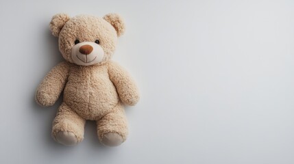 Obraz premium Teddy bear sitting alone with a blue background