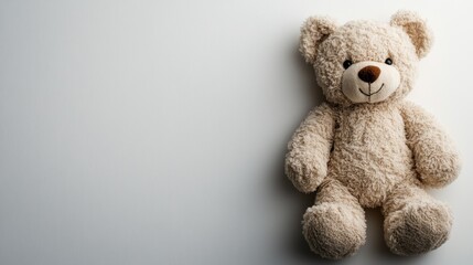 Obraz premium Teddy bear sitting alone with a blue background