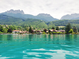 Talloires village on lake Annecy, view from azure water.