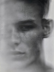 Fototapeta premium A close-up of a man's face, blurred and in black and white.