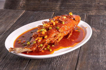 fried fish in sweet and sour sauce on wood table. Chinese food. food concept.