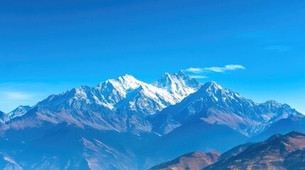 Expansive Snow-Capped Mountain Range Beneath Clear Blue Sky