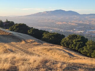 Mt Diablo rises tall above the San Ramon valley as viewed from the trails at Pleasanton Ridge park in Northern California