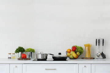 Stylish kitchen interior with white brick wall. Space for text